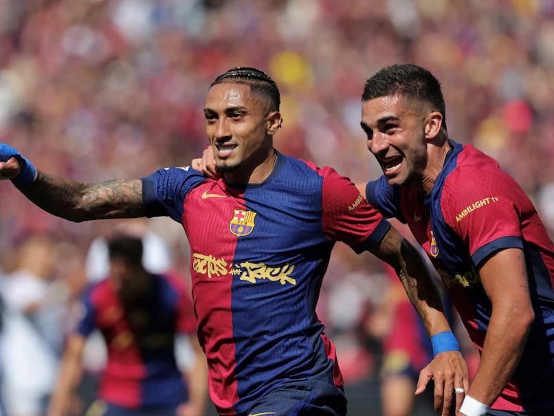 Raphinha (centre) scored a double for Barcelona in 4-3 win over Real Madrid.© AFP